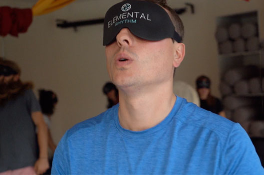 A man engaged in breathwork exercise during a session.
